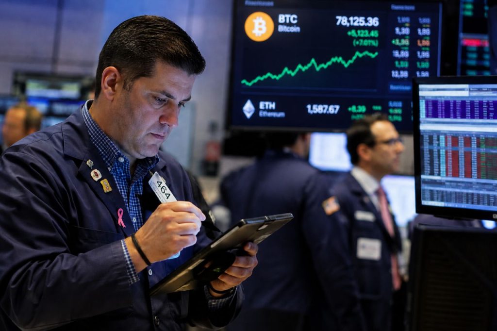 Trader al lavoro su un tablet, circondato da monitor finanziari con grafici di mercato in rialzo